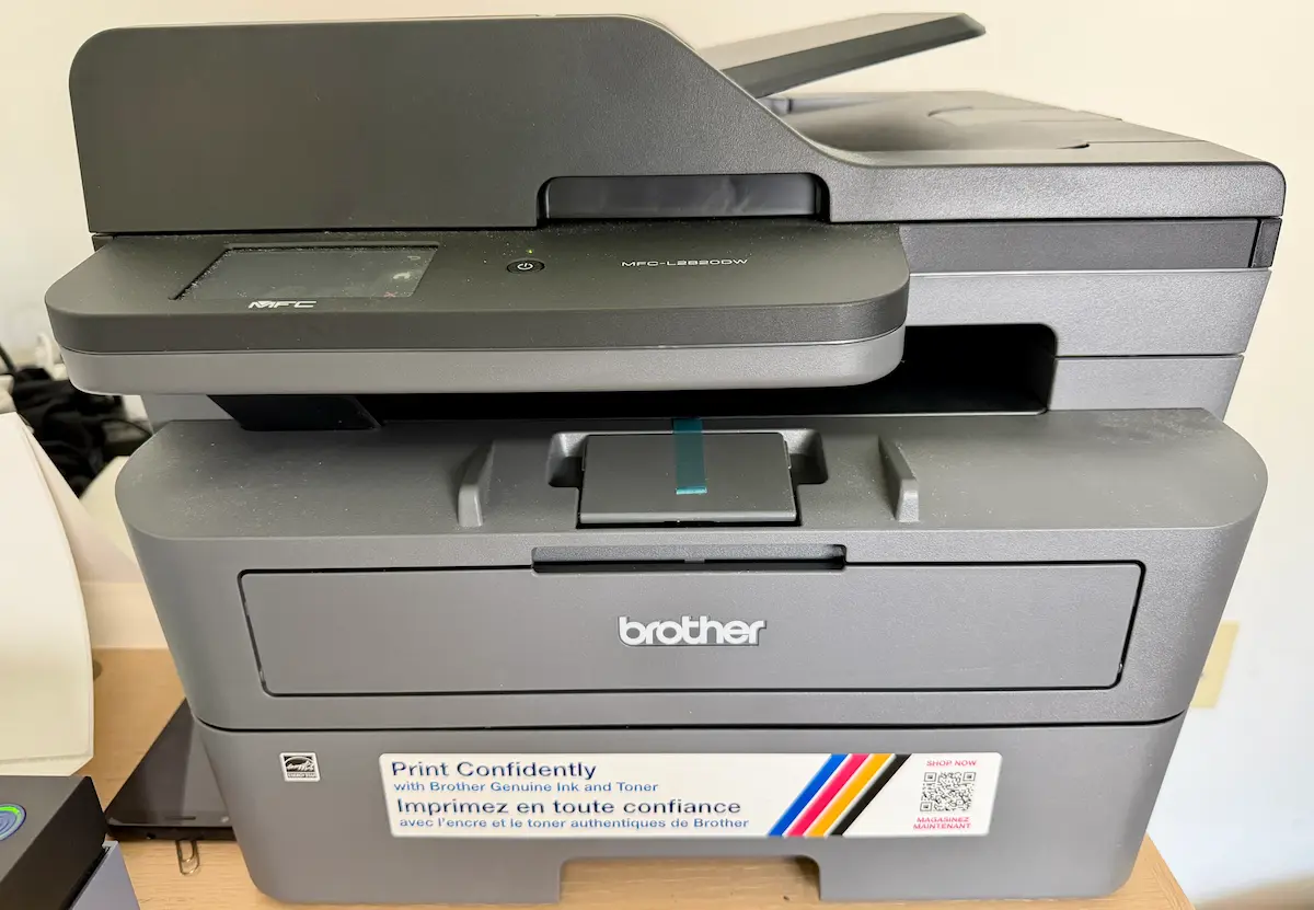 Brother MFC-L2820DW laser printer in my home office, front view showing the touchscreen and document feeder